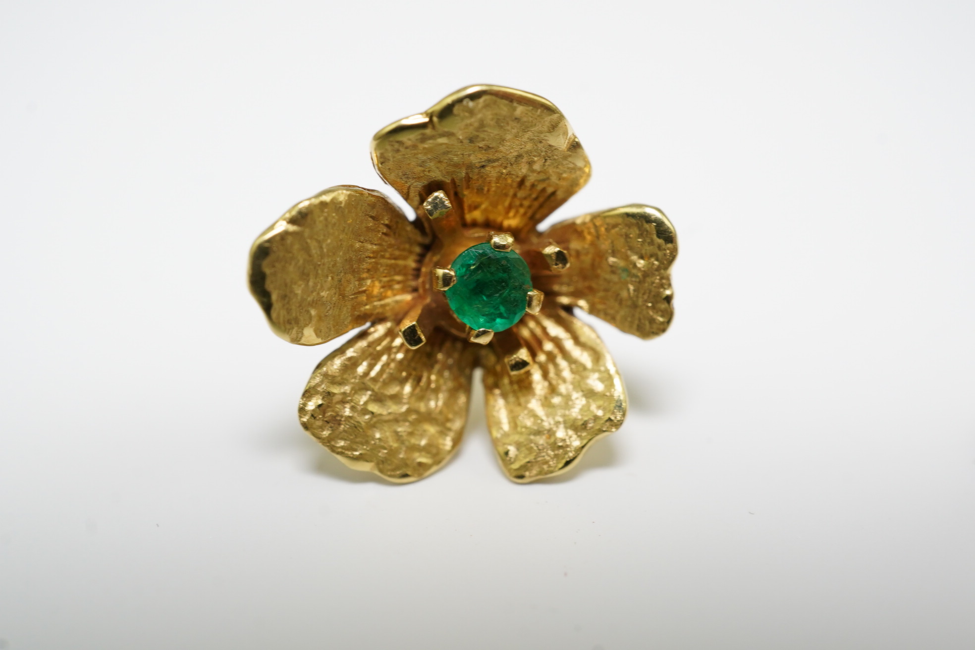 A pair of 1970's 18ct gold and single stone emerald set flower head earrings